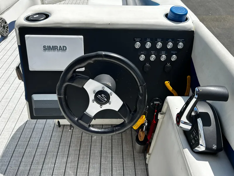 Slide: The Image of Steering console of a 2005 Evolution 26 boat with Simrad navigation system. - 8
