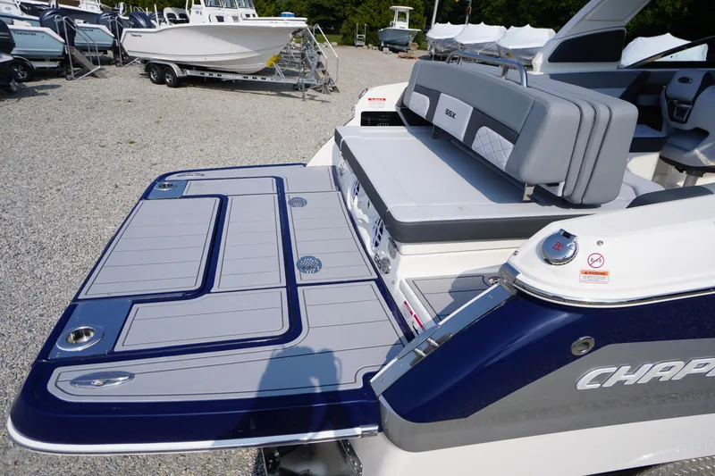 Slide: The Image of 2025 Chaparral 267 SSX boat with sleek design and modern interior, docked outdoors. - 14