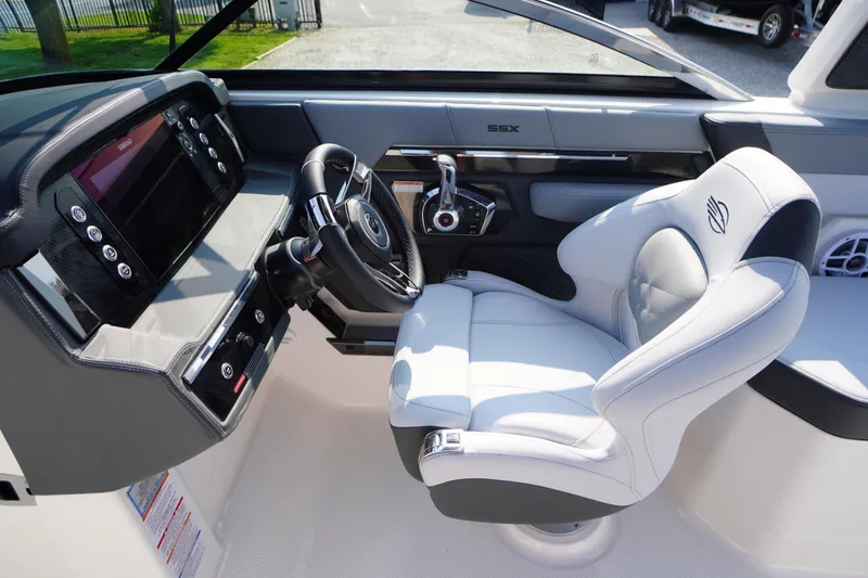 Slide: The Image of 2025 Chaparral 267 SSX boat interior with sleek steering and luxurious seating. - 33