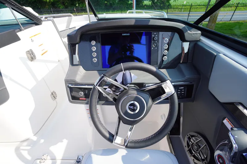 Slide: The Image of 2025 Chaparral 267 SSX boat cockpit with modern steering and digital display. - 28