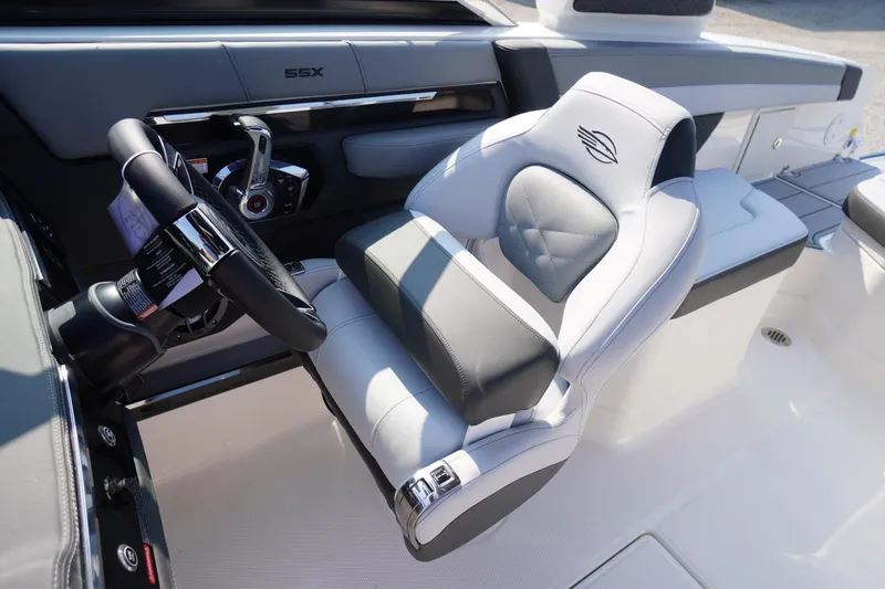 Slide: The Image of 2025 Chaparral 267 SSX boat interior with modern dashboard and luxurious seating. - 34
