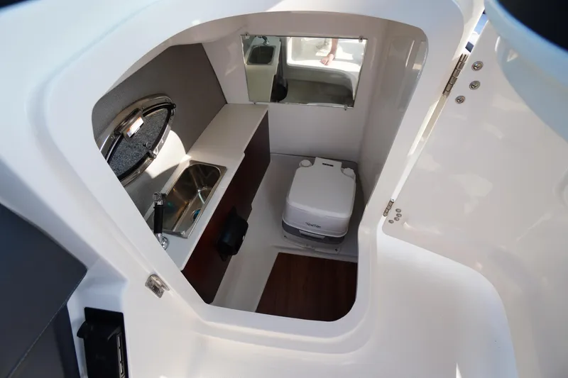 Slide: The Image of Portable toilet in 2025 Chaparral 267 SSX boat interior. - 41