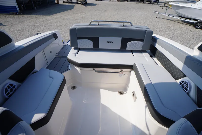 Slide: The Image of 2025 Chaparral 267 SSX boat interior with cushioned seating and speaker. - 46