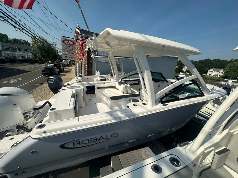 The Image of 2025 Robalo R257 Dual Console boat displayed outdoors on a sunny day. - 0