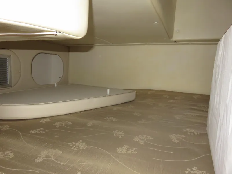 Slide: The Image of Interior cabin of 2008 Rinker 280 Express Cruiser with beige upholstery. - 14
