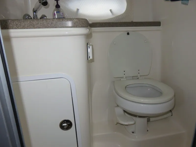 Slide: The Image of 2008 Rinker 280 Express Cruiser bathroom with toilet and sink. - 16