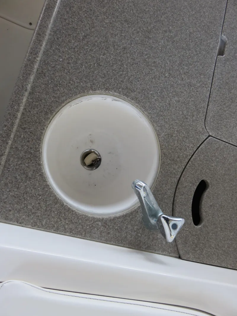 Slide: The Image of 2008 Rinker 280 Express Cruiser sink with faucet on a textured countertop. - 22