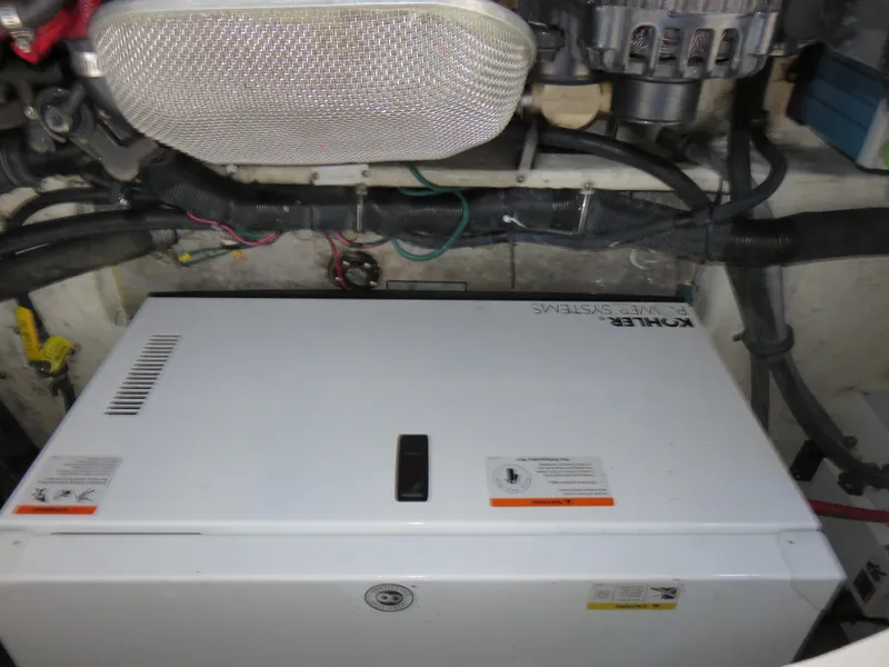 Slide: The Image of Engine compartment of 2008 Rinker 280 Express Cruiser with visible generator and wiring. - 25