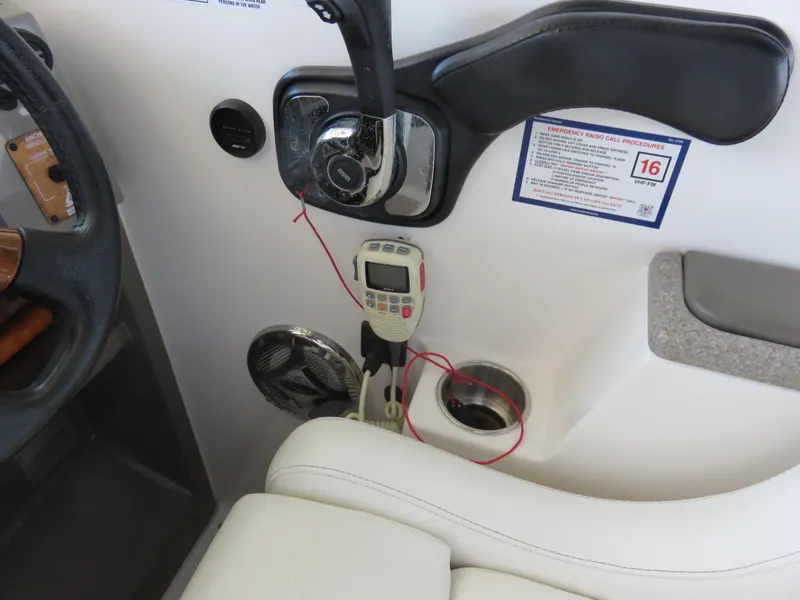 Slide: The Image of Control panel of a 2008 Rinker 280 Express Cruiser with steering wheel and electronic devices. - 26