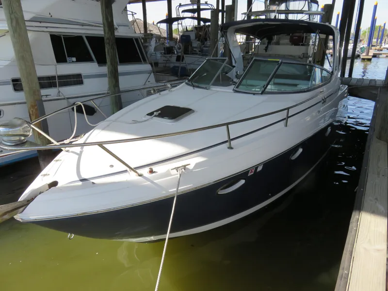 Slide: The Image of 2008 Rinker 280 Express Cruiser docked in marina, side view. - 5