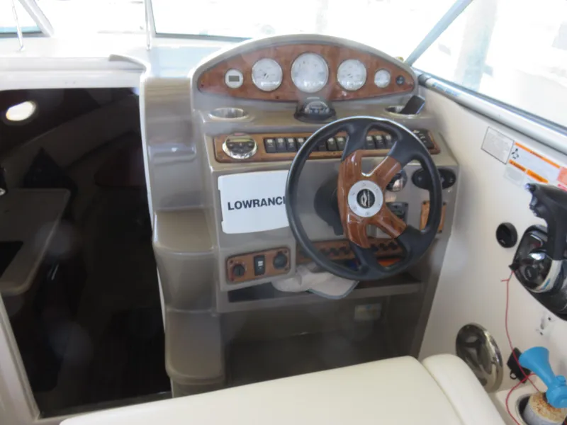 Slide: The Image of 2008 Rinker 280 Express Cruiser helm with steering wheel and instrument panel. - 6
