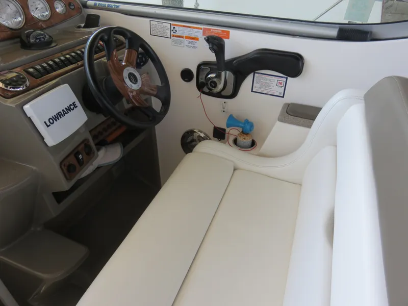 Slide: The Image of 2008 Rinker 280 Express Cruiser helm with steering wheel and control panel. - 7