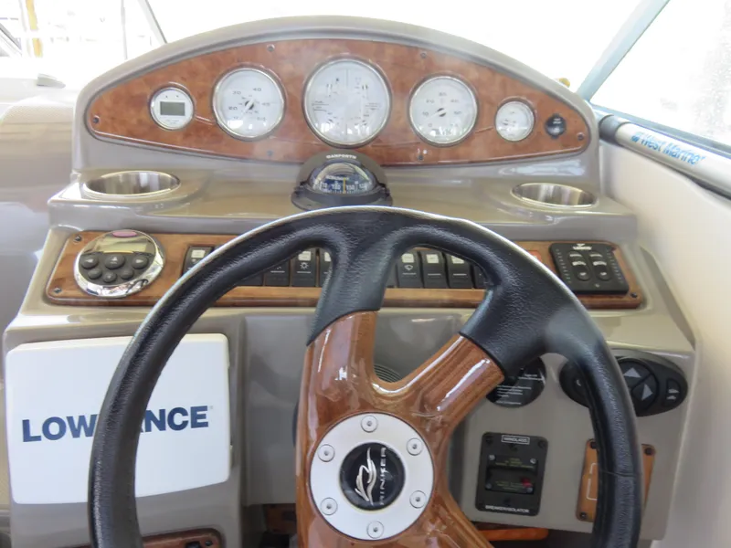 Slide: The Image of 2008 Rinker 280 Express Cruiser dashboard with steering wheel and instrument panel. - 9