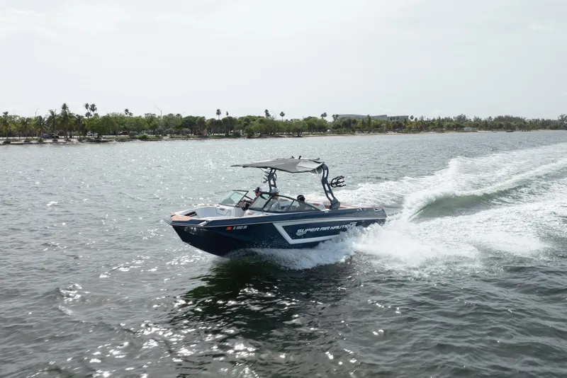 The Image of 2019 Nautique Super Air Nautique GS24 cruising on open water. - 0