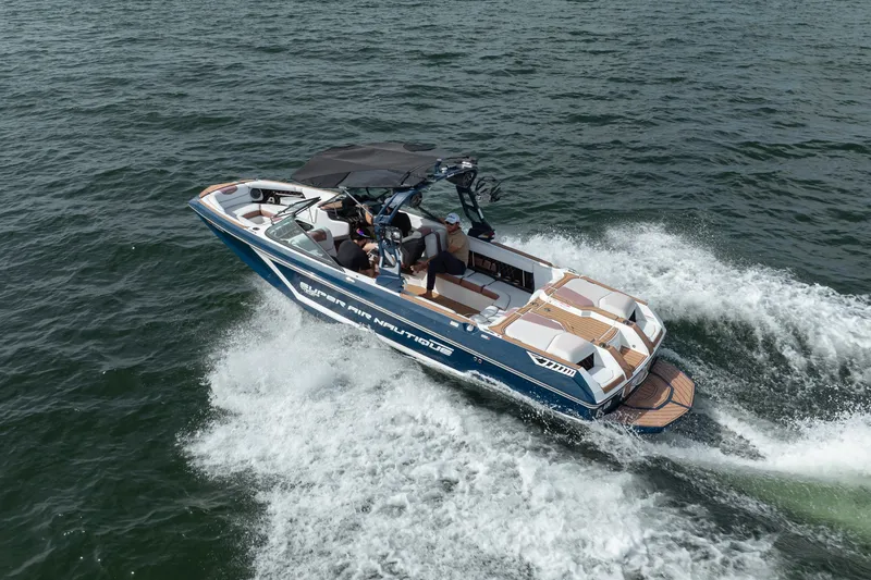 Slide: The Image of 2019 Nautique Super Air Nautique GS24 boat cruising on open water. - 11