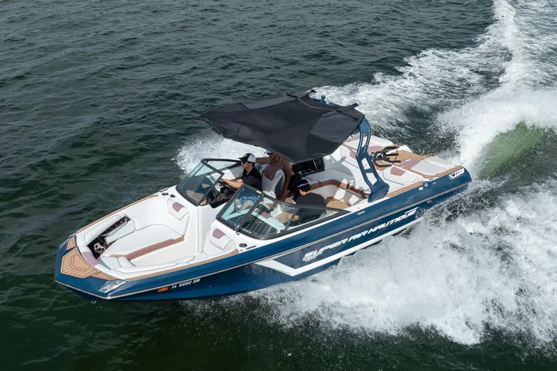 Slide: The Image of 2019 Nautique Super Air Nautique GS24 boat cruising on water. - 12