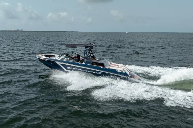 Slide: The Image of 2019 Nautique Super Air Nautique GS24 speeding on open water. - 13