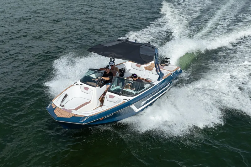 Slide: The Image of 2019 Nautique Super Air Nautique GS24 boat cruising on open water. - 14