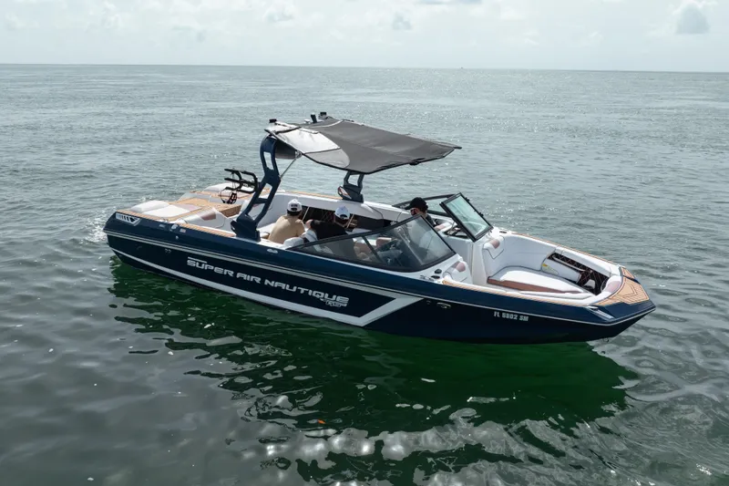 Slide: The Image of 2019 Nautique Super Air Nautique GS24 boat cruising on open water. - 18