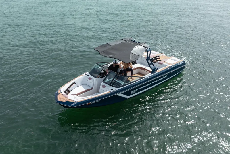 Slide: The Image of 2019 Nautique Super Air Nautique GS24 boat cruising on open water. - 20