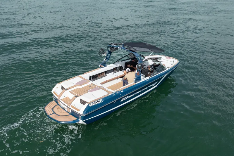 Slide: The Image of 2019 Nautique Super Air Nautique GS24 boat cruising on open water. - 21