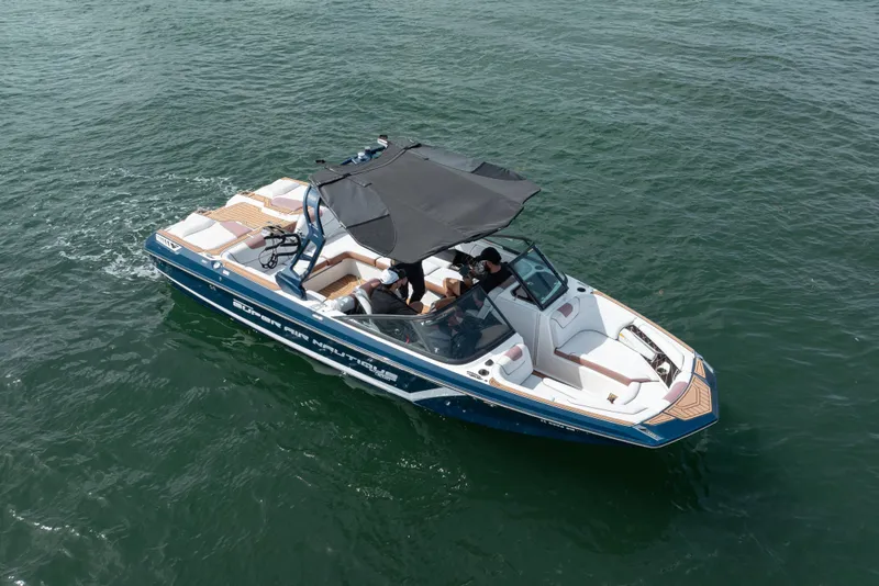 Slide: The Image of 2019 Nautique Super Air Nautique GS24 boat cruising on open water. - 22