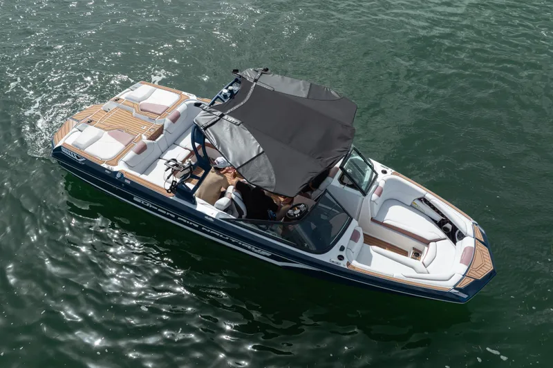 Slide: The Image of 2019 Nautique Super Air Nautique GS24 boat on water, featuring sleek design and spacious seating. - 23