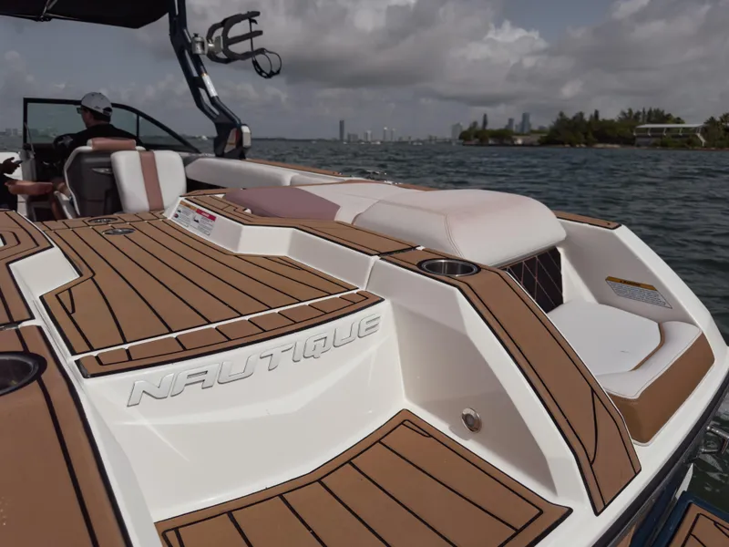 Slide: The Image of 2019 Nautique Super Air Nautique GS24 boat on water, featuring sleek deck design. - 26