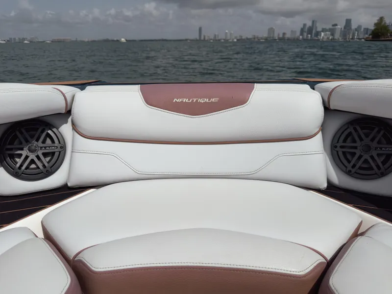 Slide: The Image of 2019 Nautique Super Air Nautique GS24 boat interior with speakers, overlooking a city skyline. - 29