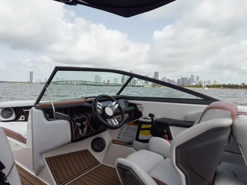 Slide: The Image of 2019 Nautique Super Air Nautique GS24 boat interior with city skyline in background. - 31