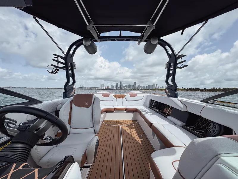 Slide: The Image of 2019 Nautique Super Air Nautique GS24 boat interior with city skyline in background. - 32