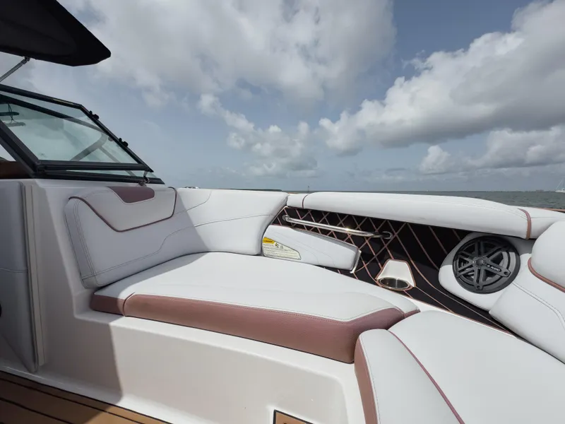 Slide: The Image of 2019 Nautique Super Air Nautique GS24 boat interior with plush seating and speaker system. - 38