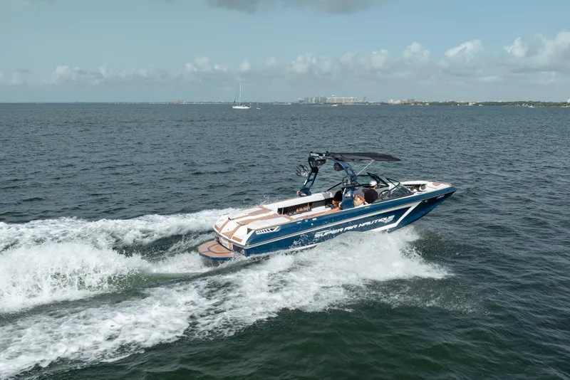 Slide: The Image of 2019 Nautique Super Air Nautique GS24 cruising on open water. - 4