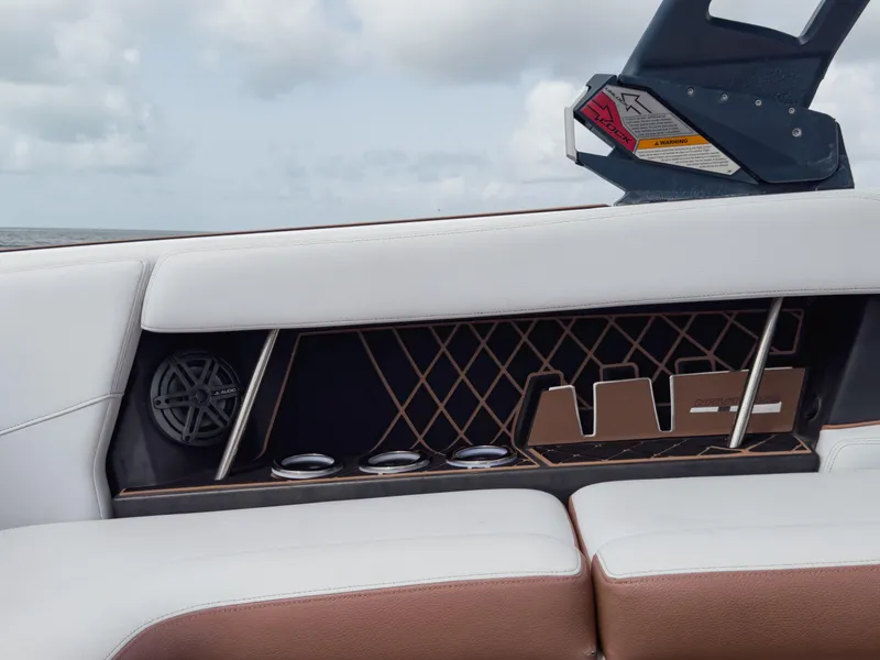 Slide: The Image of 2019 Nautique Super Air Nautique GS24 interior detail with speaker and cup holders. - 42