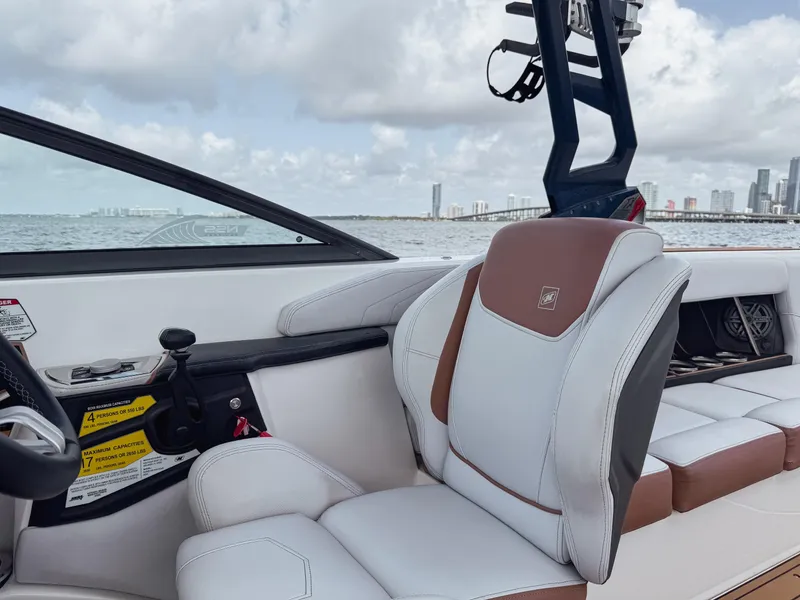 Slide: The Image of 2019 Nautique Super Air Nautique GS24 interior with white and brown seating, ocean view. - 49