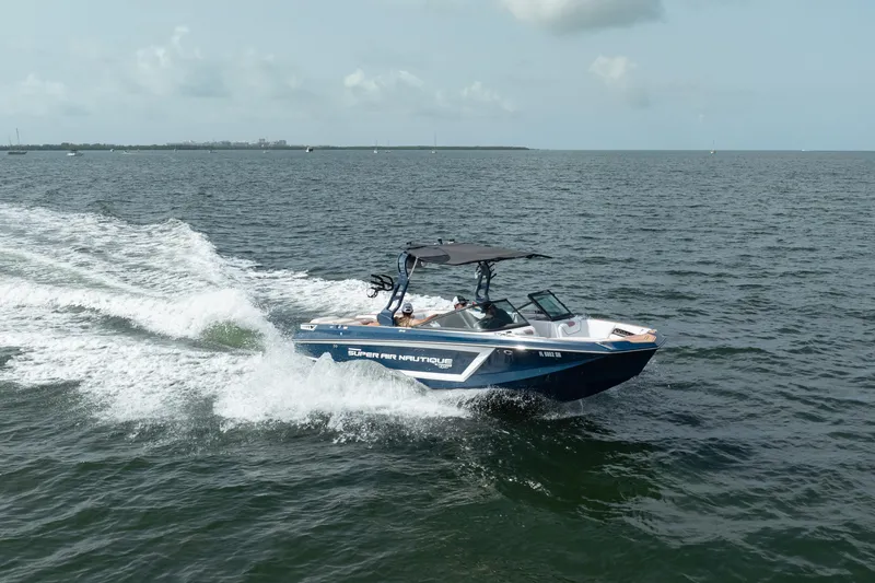 Slide: The Image of 2019 Nautique Super Air Nautique GS24 speeding on open water. - 5