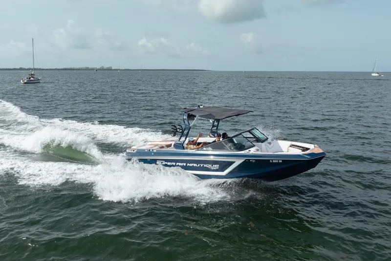 Slide: The Image of 2019 Nautique Super Air Nautique GS24 cruising on open water. - 6