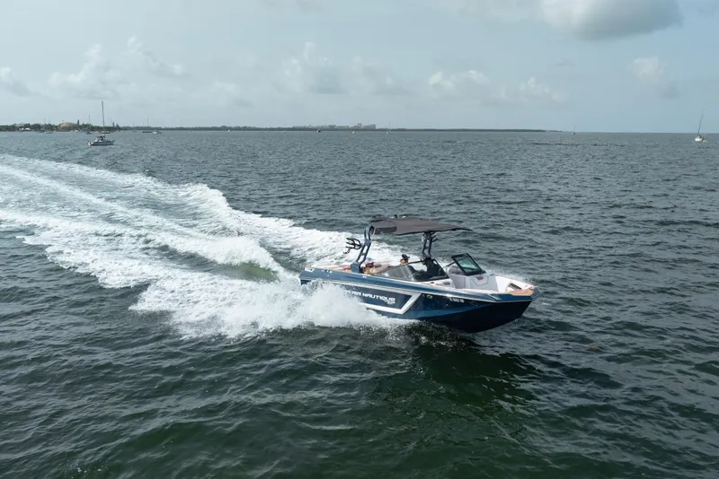 Slide: The Image of 2019 Nautique Super Air Nautique GS24 speeding on open water under cloudy skies. - 7