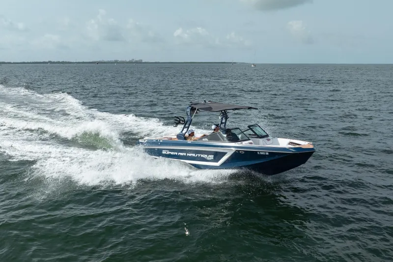 Slide: The Image of 2019 Nautique Super Air Nautique GS24 speeding on open water. - 8