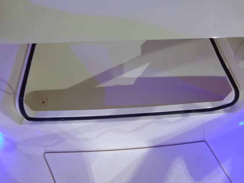 Slide: The Image of 2023 Cobia 280 Center Console storage compartment with blue LED lighting. - 12