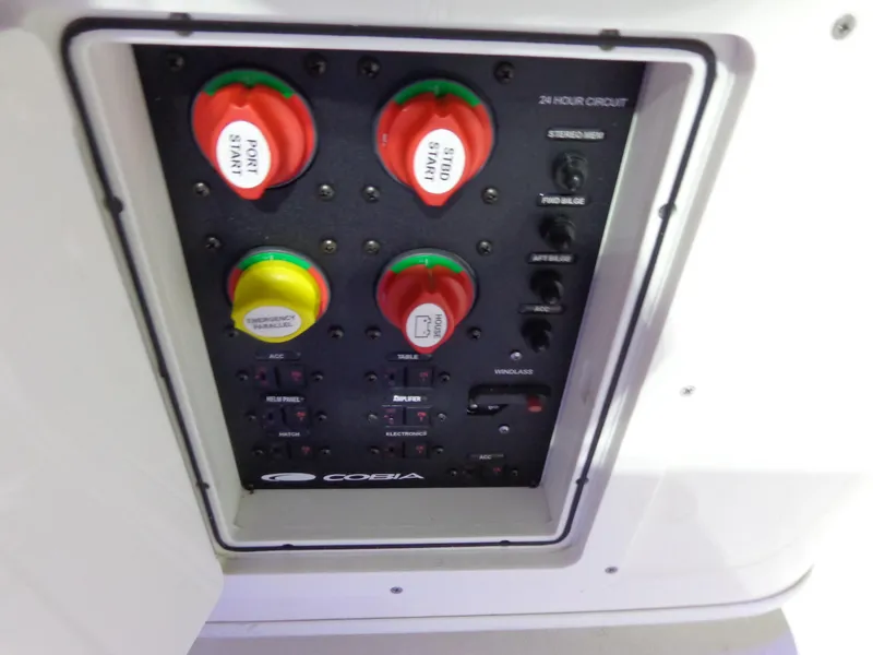 Slide: The Image of Control panel of 2023 Cobia 280 Center Console boat with labeled switches and dials. - 15