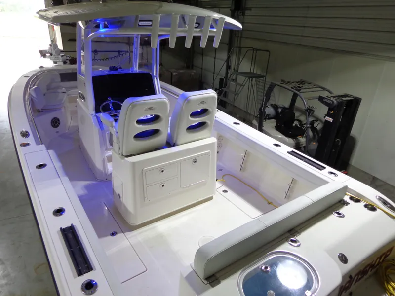 Slide: The Image of 2023 Cobia 280 Center Console boat interior with illuminated seating and storage. - 16
