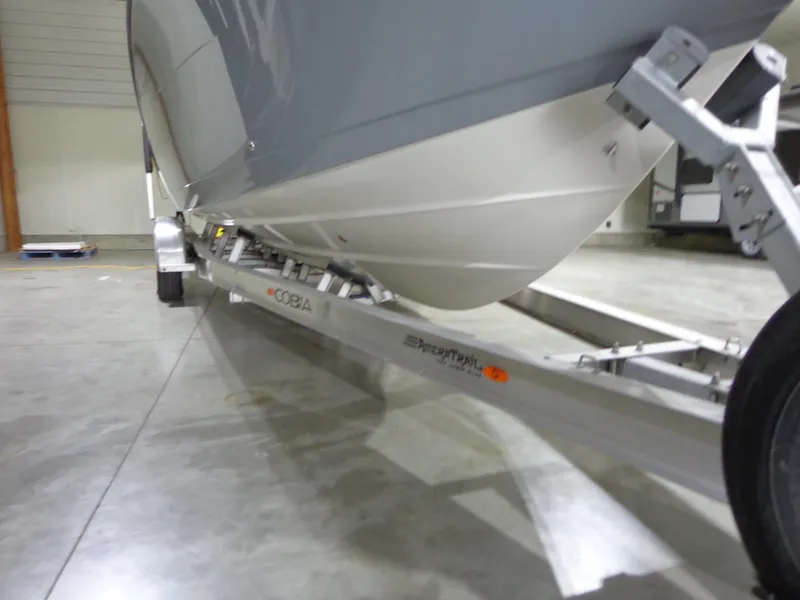 Slide: The Image of 2023 Cobia 280 Center Console boat on trailer in a garage. - 19