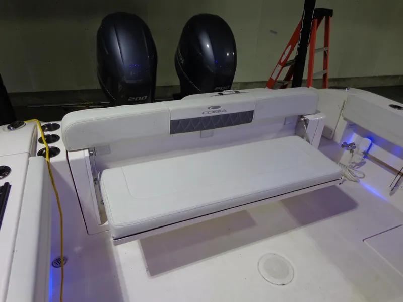 Slide: The Image of 2023 Cobia 280 Center Console boat with dual engines and foldable seating. - 25