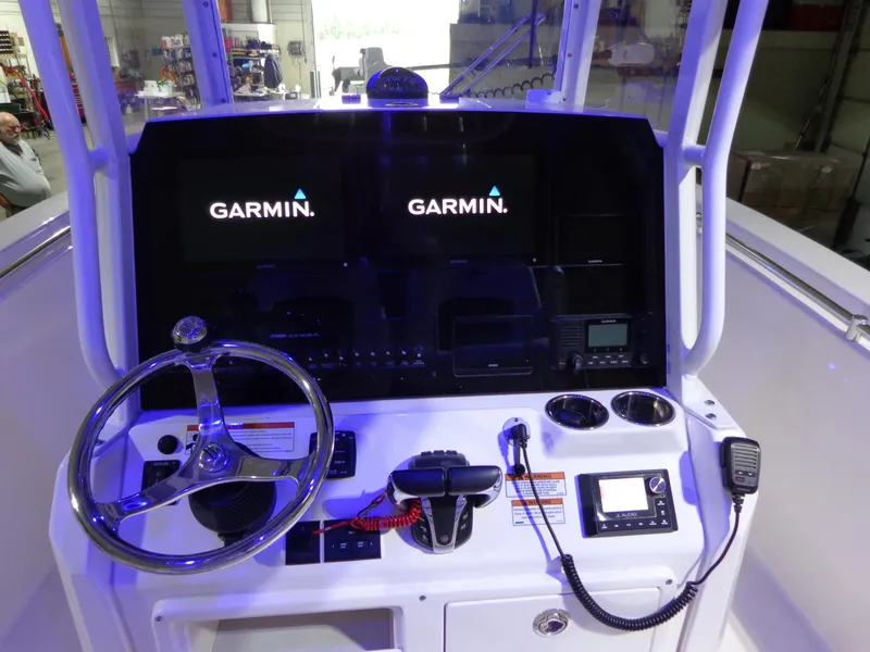 Slide: The Image of 2023 Cobia 280 Center Console dashboard with Garmin displays and steering wheel. - 29