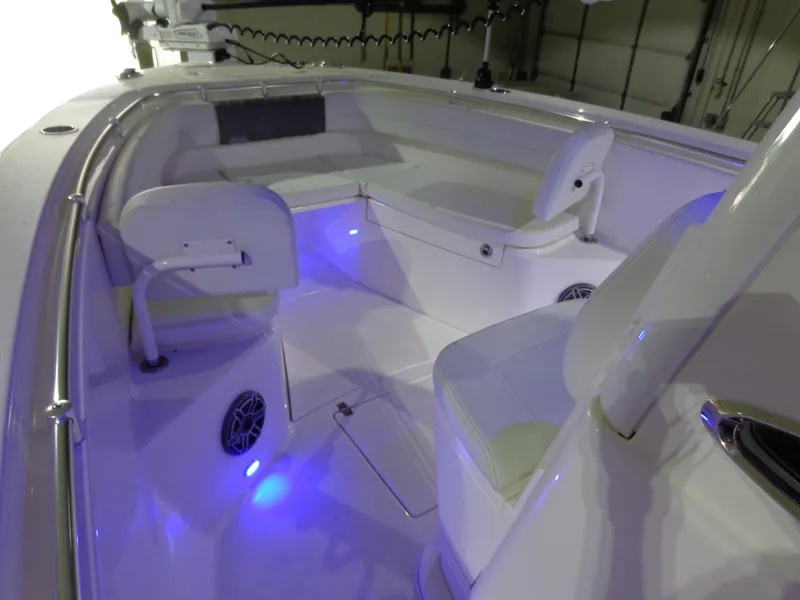 Slide: The Image of 2023 Cobia 280 Center Console boat interior with blue LED lighting. - 34