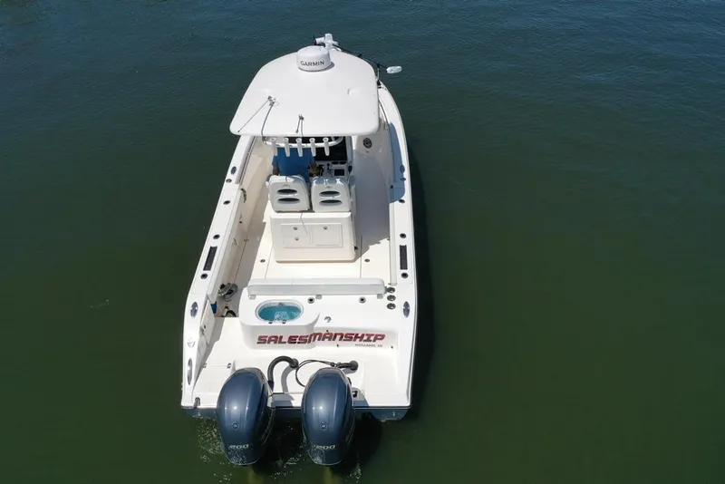 Slide: The Image of 2023 Cobia 280 Center Console boat with dual engines on calm water. - 43