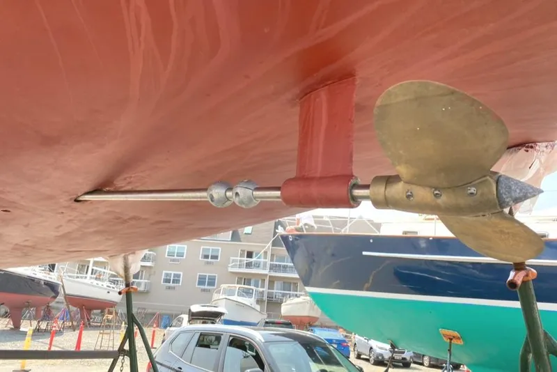 Slide: The Image of 1986 Express 37 sailboat propeller and shaft, dry docked with other boats in background. - 10