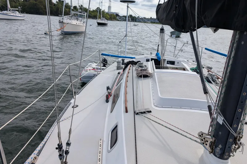 Slide: The Image of 1986 Express 37 sailboat deck view on a calm lake with other boats. - 16
