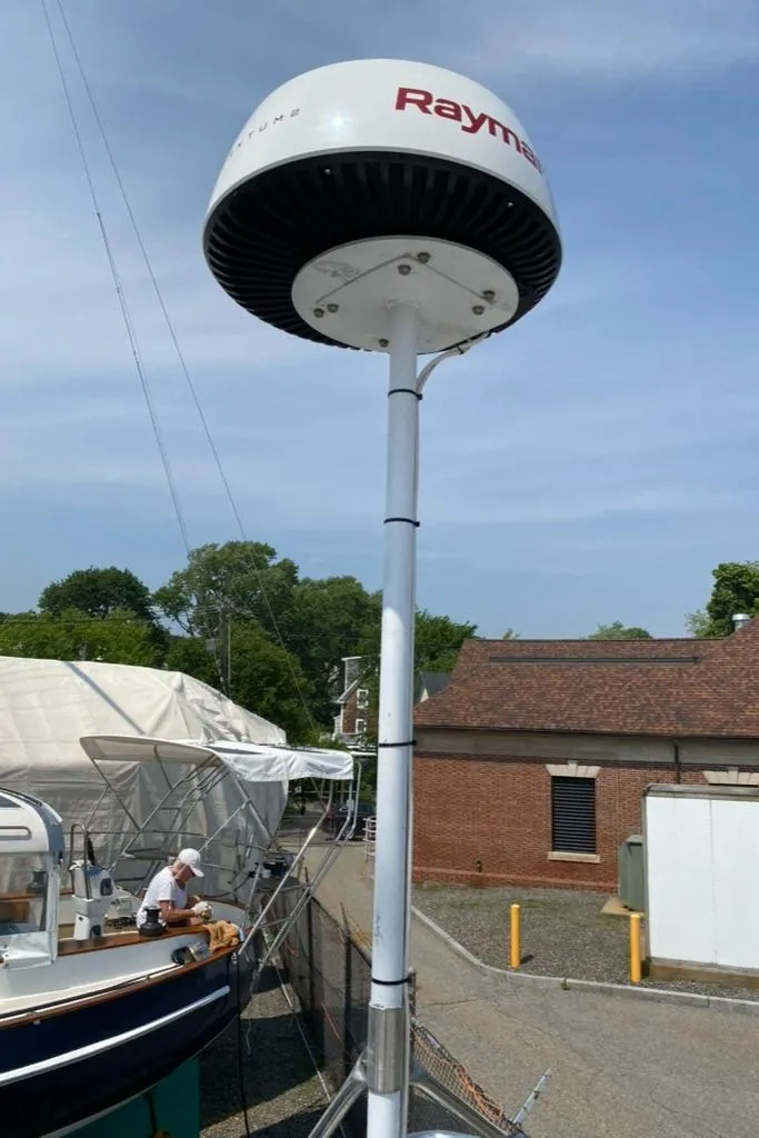 Slide: The Image of Radar dome on Express 37 sailboat, 1986 model, docked near brick building. - 25